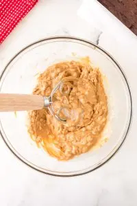 A bowl filled with peanut butter topping for peanut butter brownies - Hostess At Heart