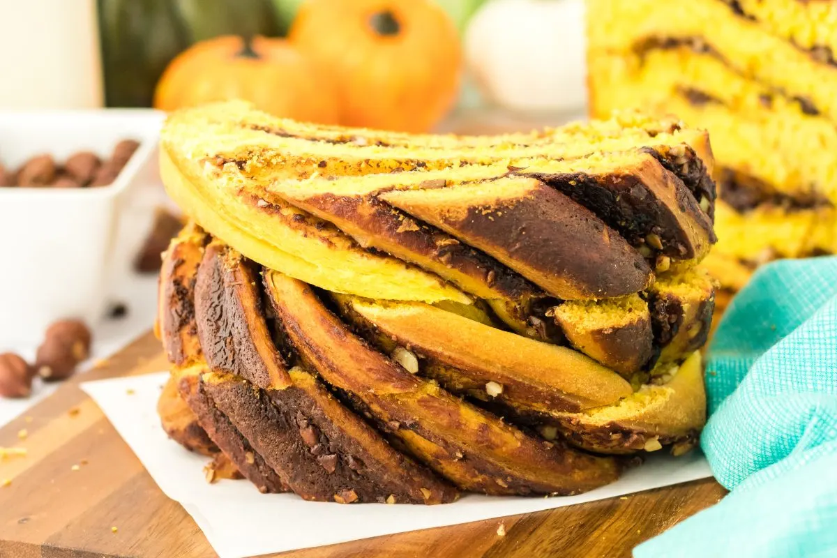 Two slices of swirled pumpkin bread filled with chocolate and chopped hazelnuts - Hostess At Heart