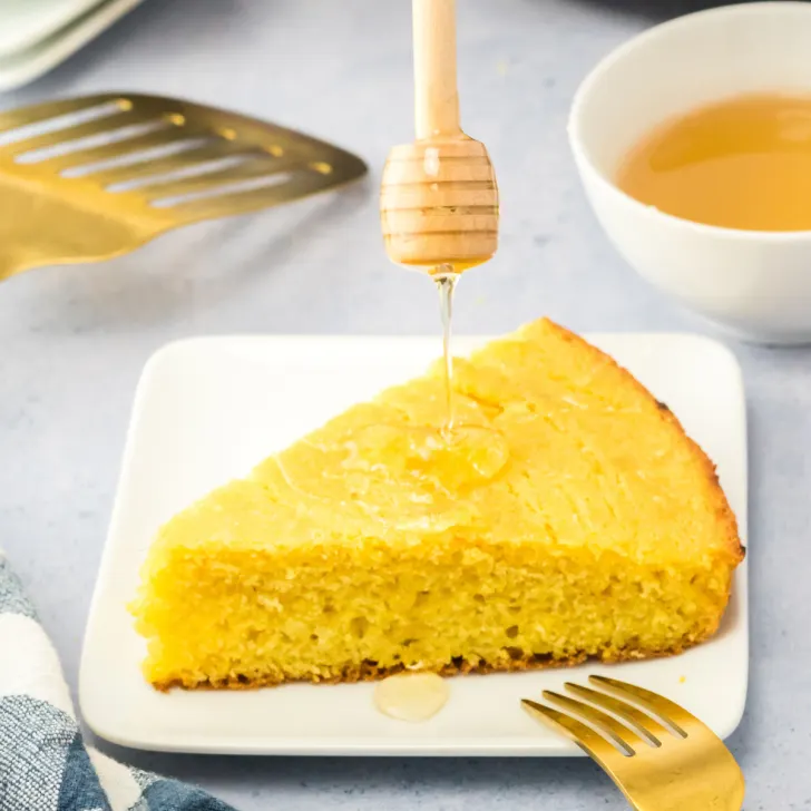 Honey drizzled on a slice of cornbread - Hostess At Heart