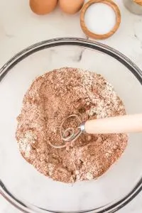 A bowl containing flour and cocoa that's been sifted together - Hostess At Heart
