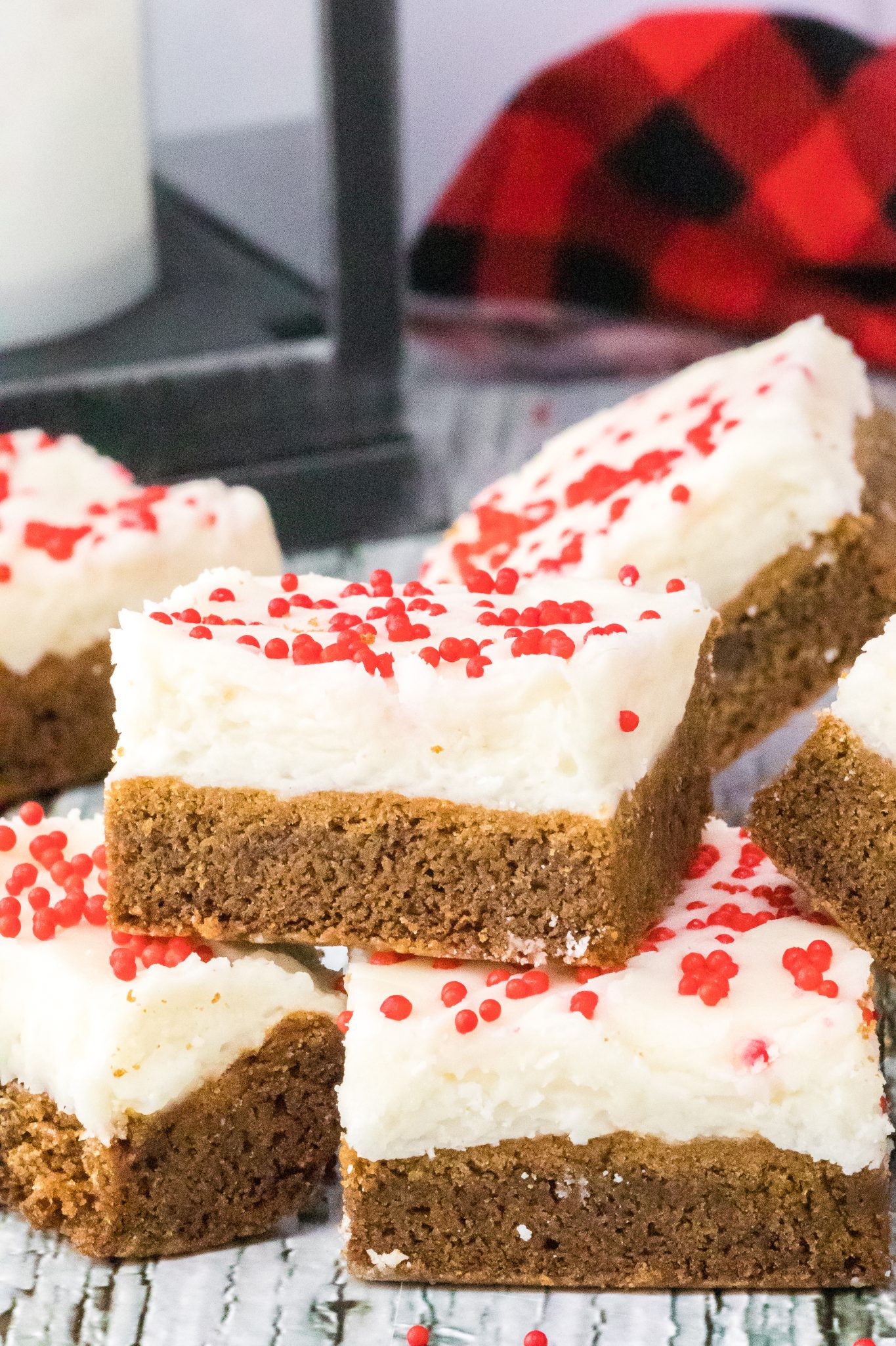 Sideview of slices of ginger cookie bars topped with frosting and sprinkles - Hostess At Heart