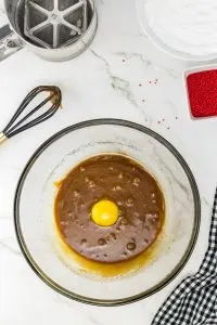 A bowl filled with blended sugar and molasses topped with an egg - Hostess At Heart
