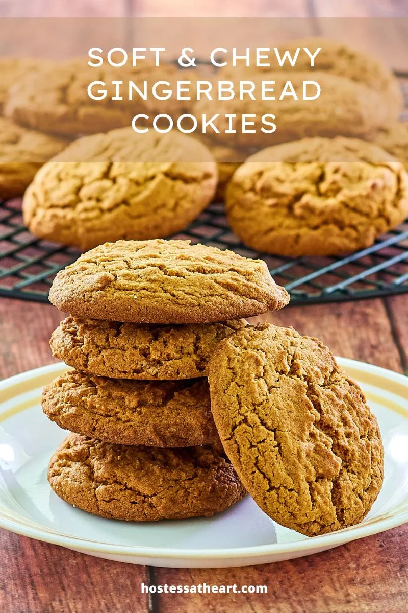 A stack of soft gingerbread cookies on a plate with another cookie propped against the stack. Hostess At Heart