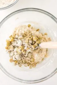 A Danish dough hook mixing chopped green olives into mixed bread dough. Hostess At Heart