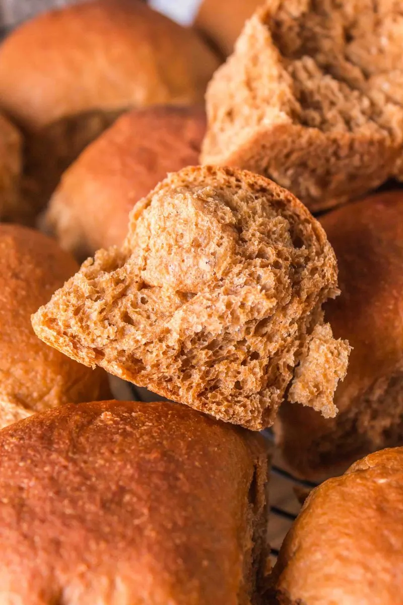 A baked brown bread rolls torn in half showing a soft fluffy interior - Hostess At Heart