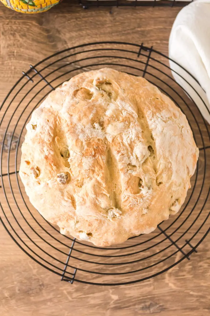 Top down view of a round loaf of homemade bread stuffed with olives - Hostess At Heart