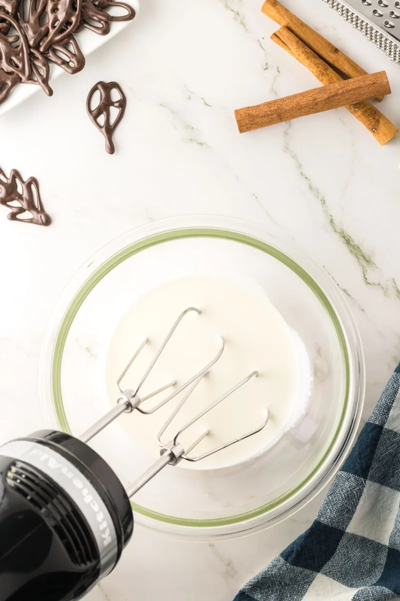 A whipping cream in a bowl to make pumpkin mousse with meringue - Hostess At Heart