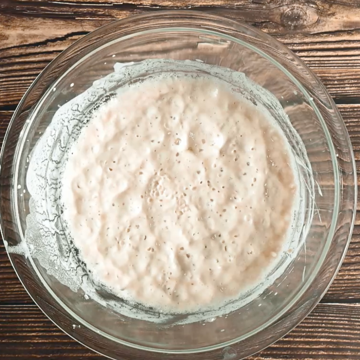 A bowl of bubbly poolish in a mixing bowl - Hostess At Heart