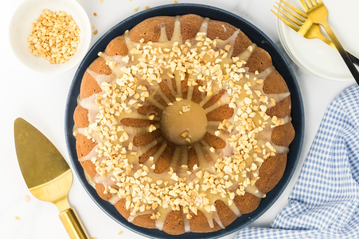 Top down view of a baked peanut buttr bundt cake topped with pb glaze and chopped peanuts - Hostess At Heart
