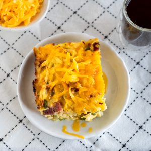 Top down view of a slice of corned beef breakfast casserole topped with cheese.