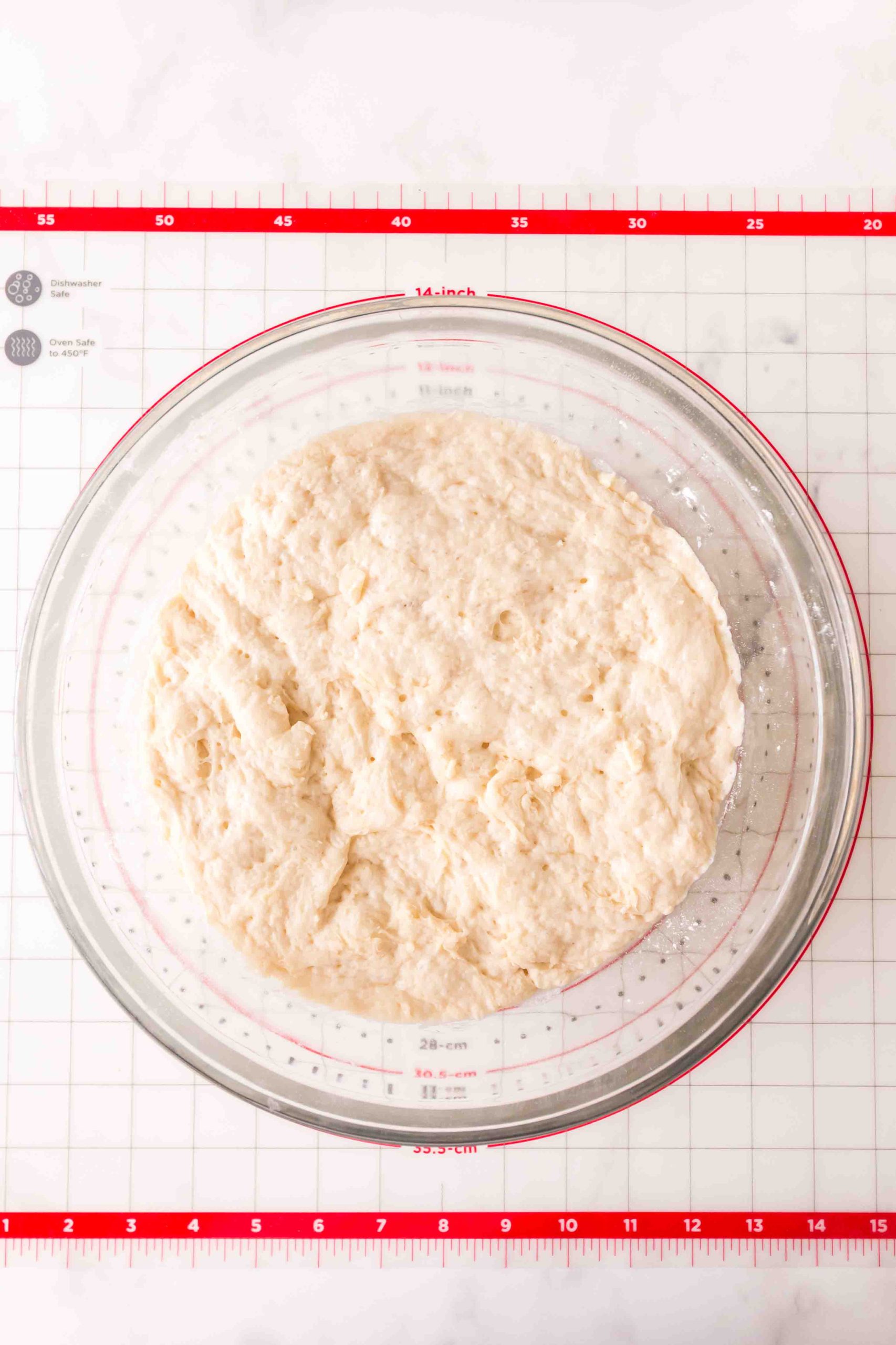 Proofed dough in a large glass bowl. Hostess At Heart