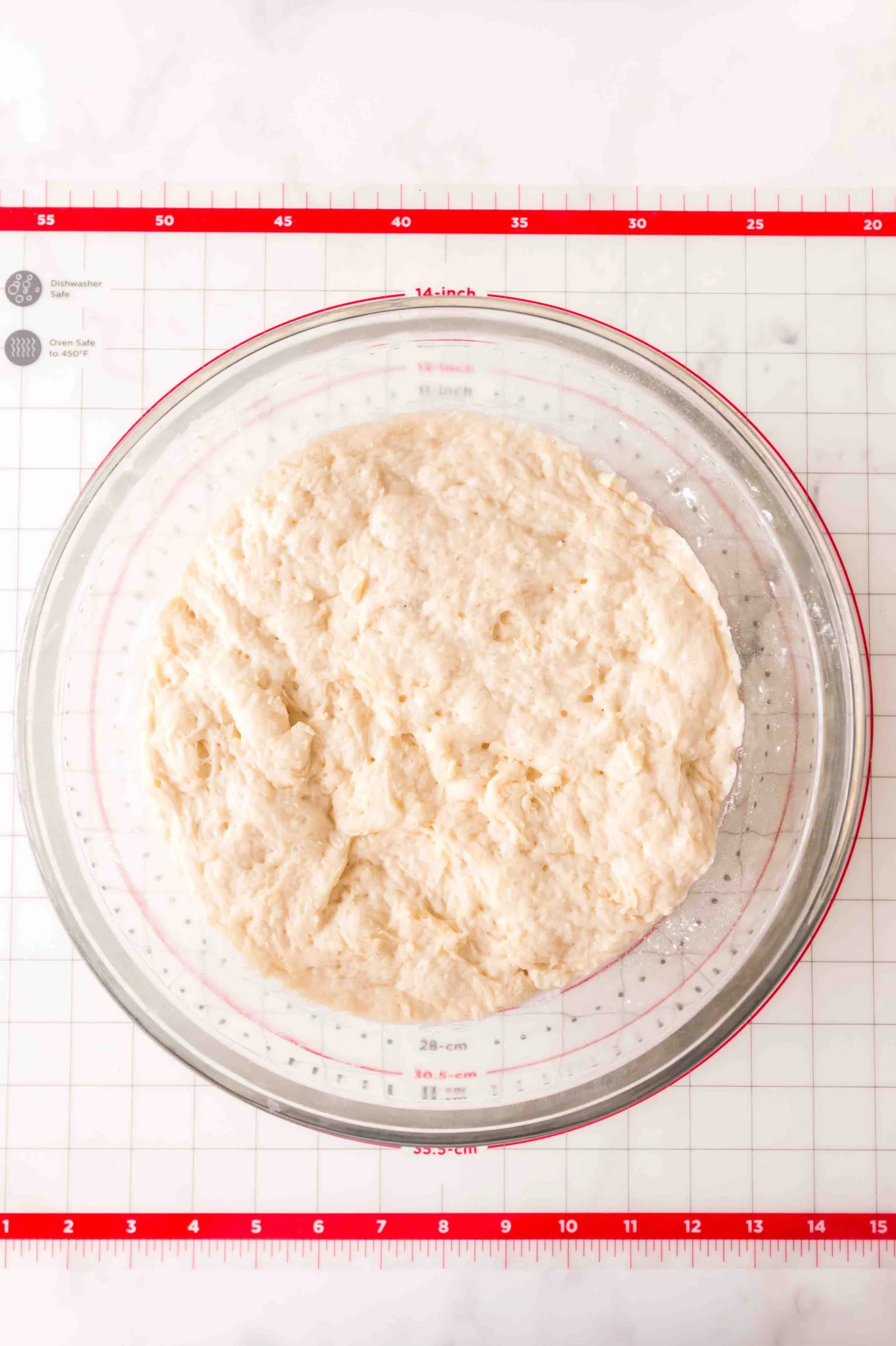 Proofed dough in a large glass bowl. Hostess At Heart
