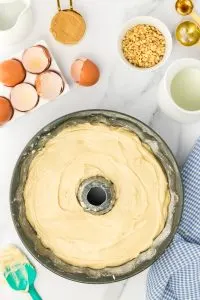 Top down view of bundt cake pan filled with peanut butter cake batter - Hostess At Heart