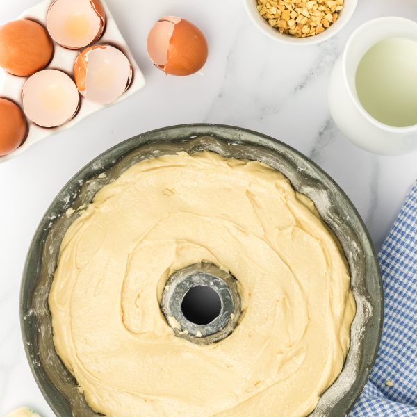 Top down view of bundt cake pan filled with peanut butter cake batter - Hostess At Heart