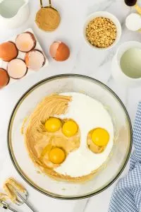 A bowl filled with peanut butter, eggs, and sugar waiting to be creamed together. Hostess At Heart