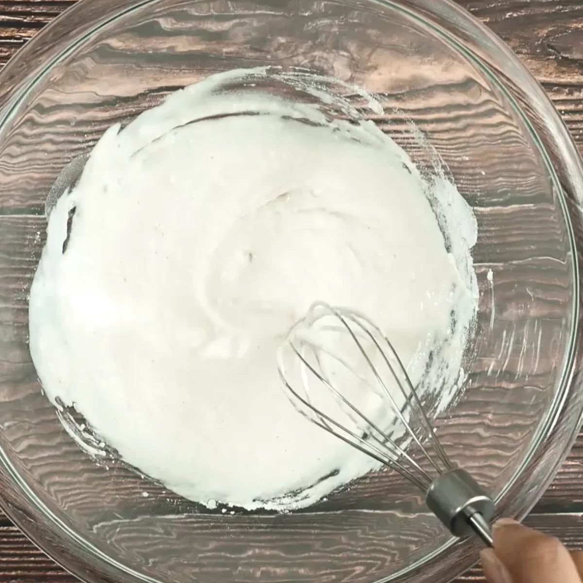 Flour and water with a touch of garlic added to a mixing bowl to make a poolish for bread. Hostess At Heart