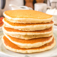 Sideview of 5 soft pancakes stacked on top of each other. Hostess At Heart