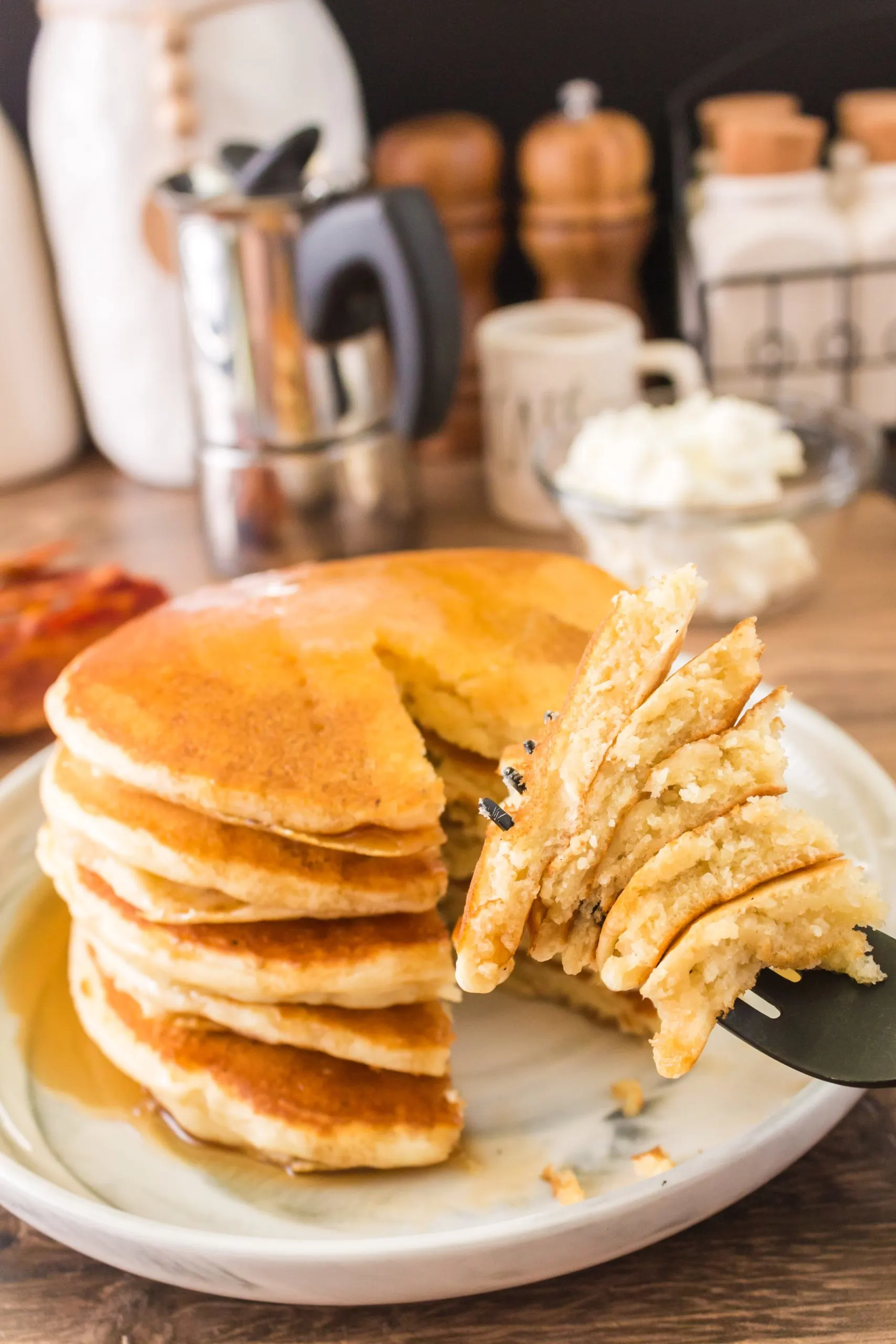 Close up of a fork stacked with a bite of 5 discard pancakes - Hostess At Heart