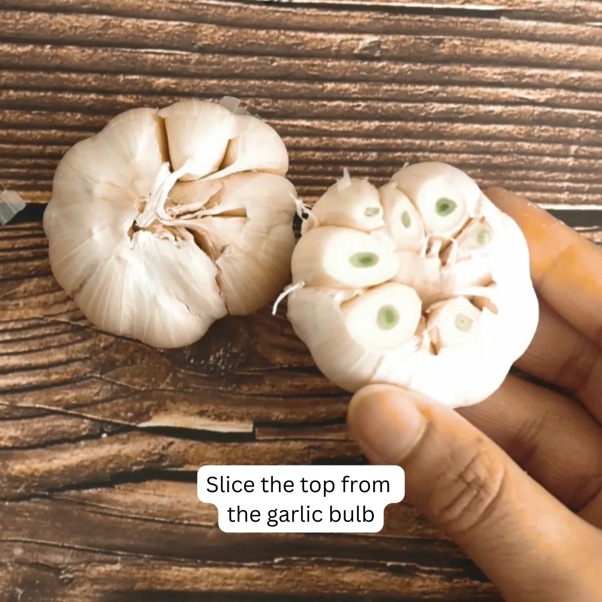 A garlic bulb with the top sliced of in preparation for roasting - Hostess At Heart