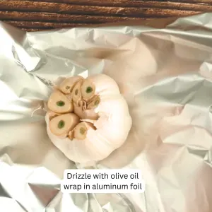 A garlic bulb on a piece of aluminum foil for baking - Hostess at Heart