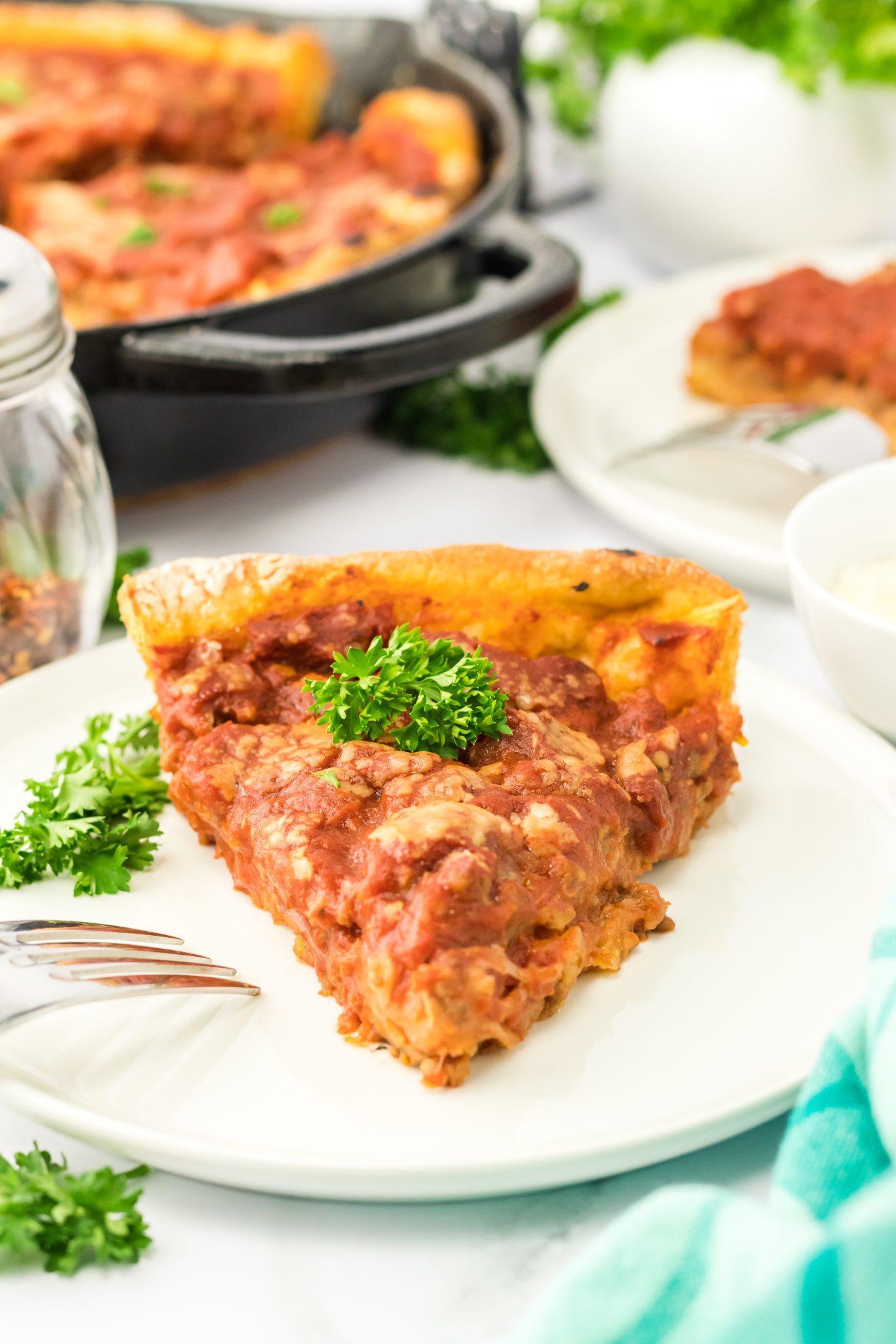 Front view of a slice of this sausage pizza on a plate. Hostess At Heart
