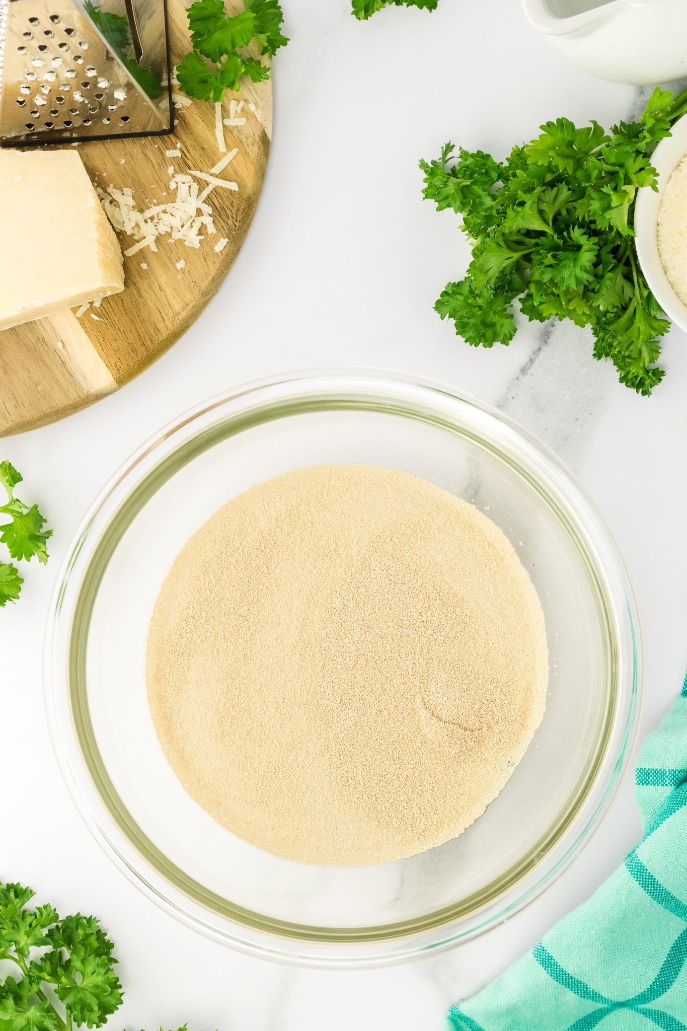 Top down view of a bowl holding dry yeast and water - Hostess At Heart
