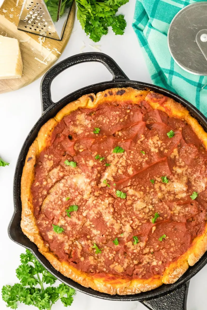 Top down view of a Chicago Deep Dish pizza baked in a cast iron skillet - Hostess At Heart