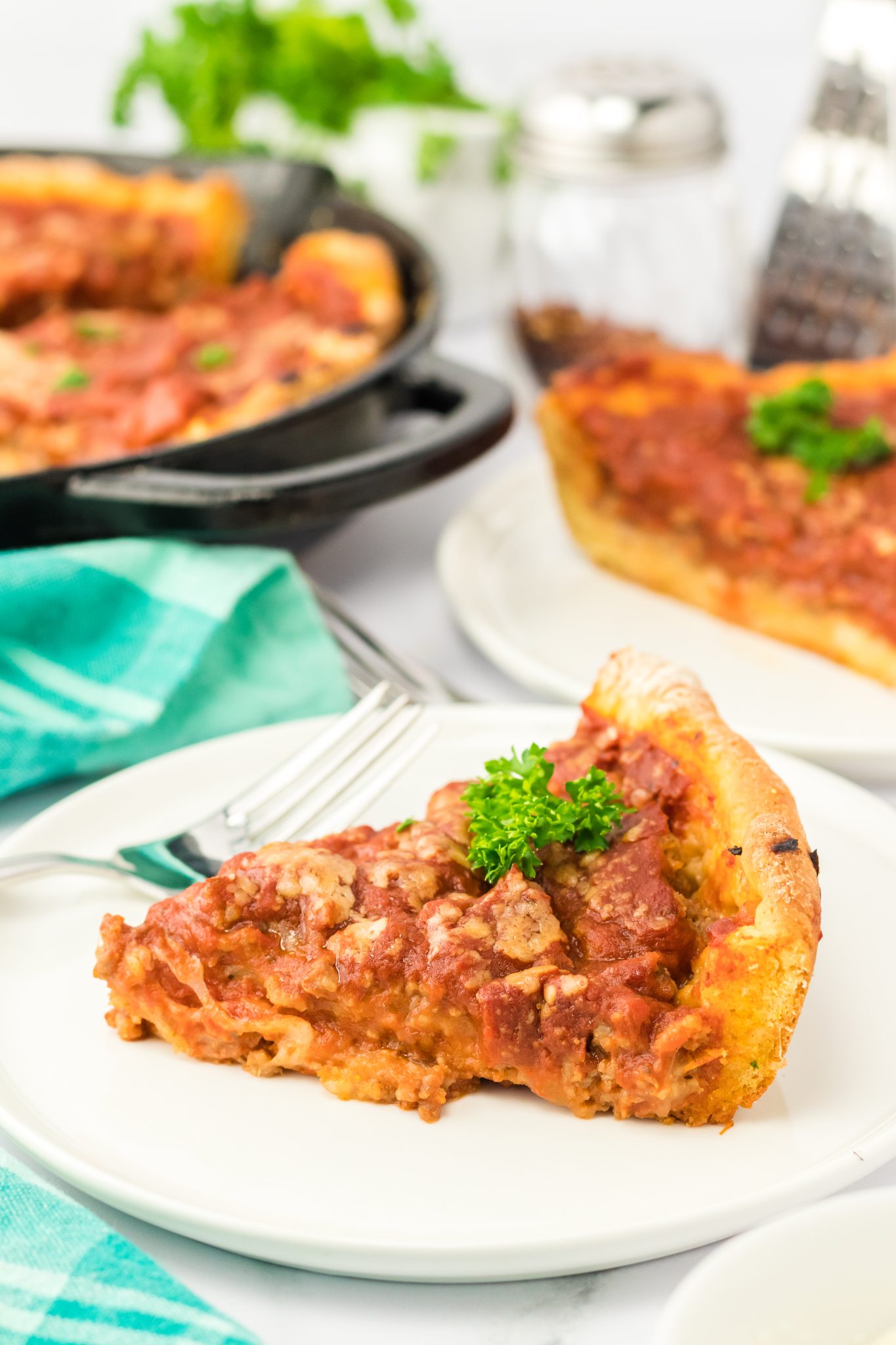 Sideview of a slice of baked sausage pizza - Hostess At Heart