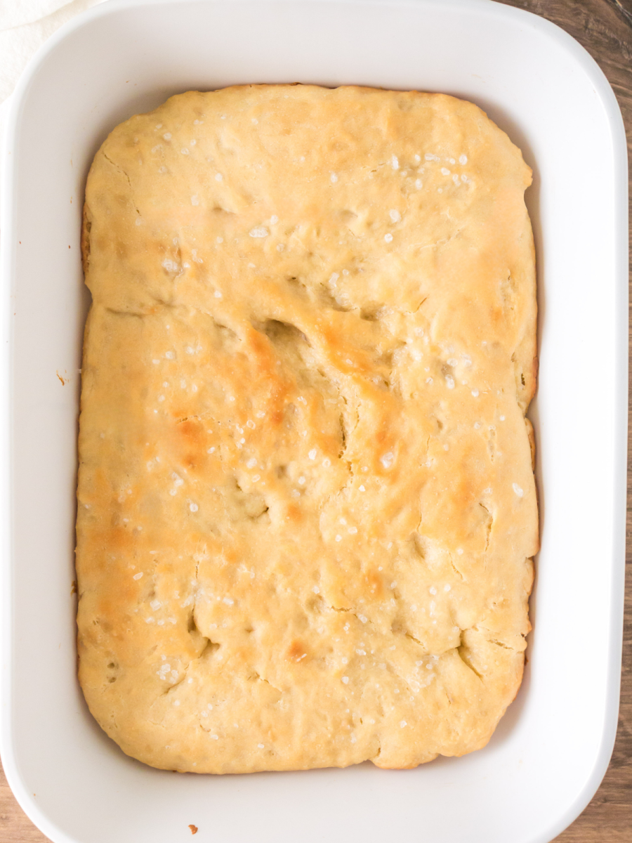 Top down view of a baking pan of baked sourdough focaccia bread - Hostess At Heart