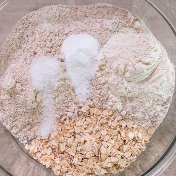 Dry Ingredients in a bowl: whole wheat flour, bread flour, rolled oats, salt, and baking soda.