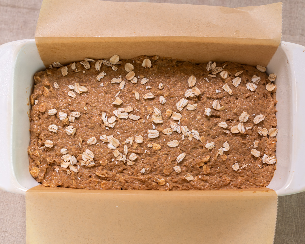 A loaf pan filled with the Irish Brown Bread dough, smushed to the edges. 