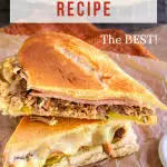 An authentic Cuban Sandwich pressed and sliced sandwich made of shredded pork, slices of ham, Swiss Cheese, pickles, and mustard -Hostess At Heart