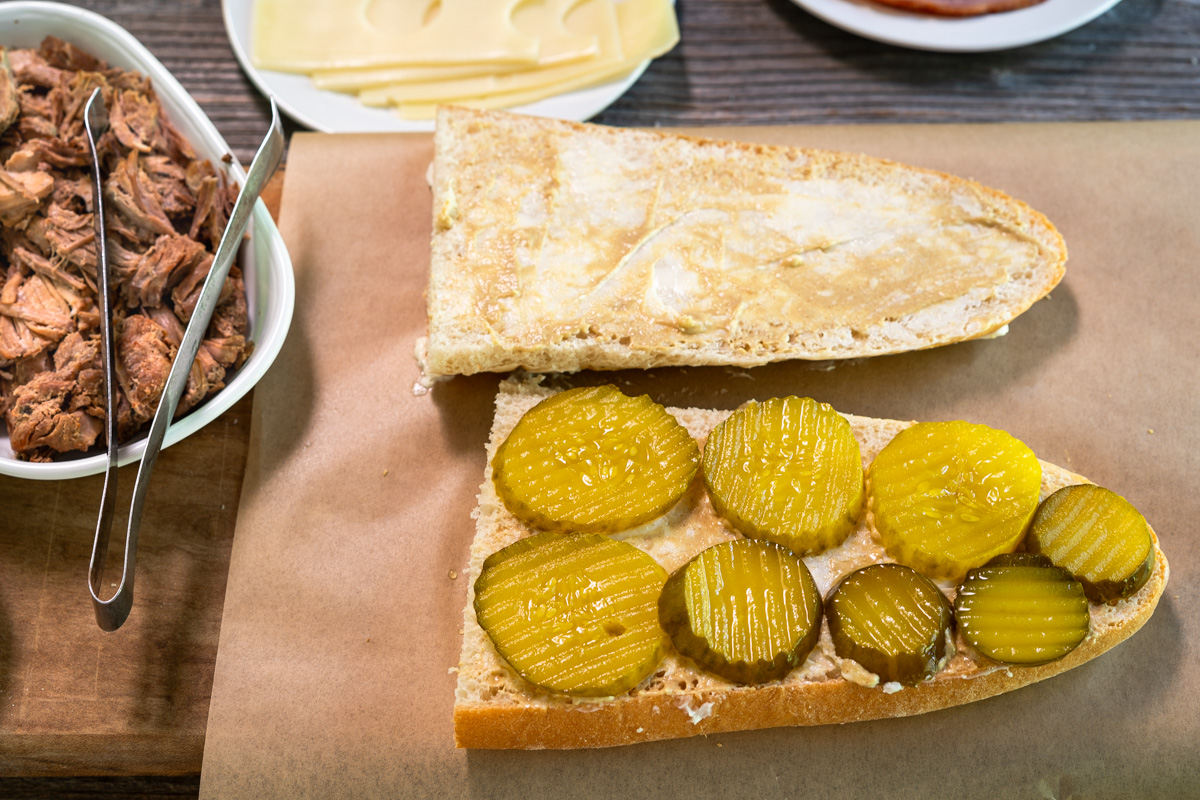 Sliced and buttered Cuban bread with a layer of sweet pickles - Hostess At Heart