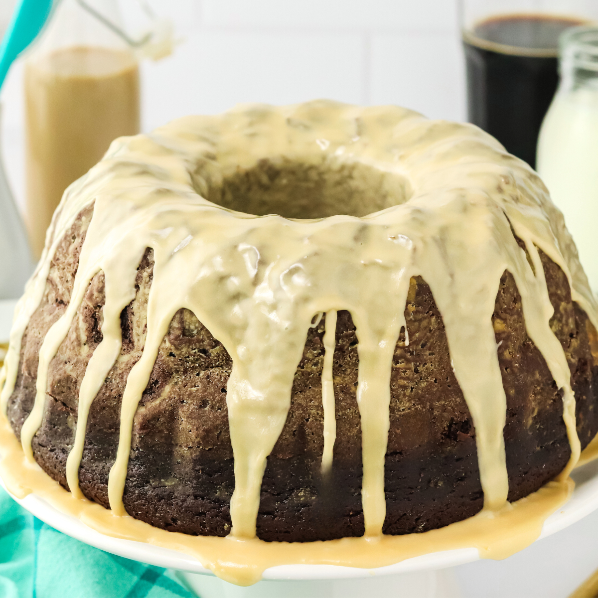 Sideview of a beautiful chocolate Guinness Cake glazed with Irish Cream glaze - Hostess At Heart