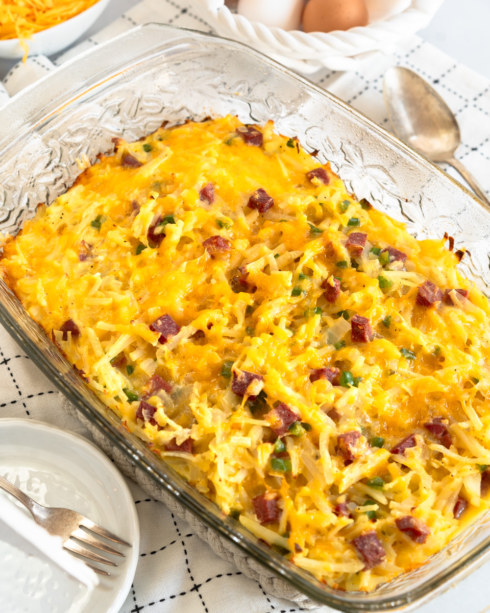 Top down view of a baking dish filled with an egg casserole containing potatoes and diced corned beef - Hostess At Heart