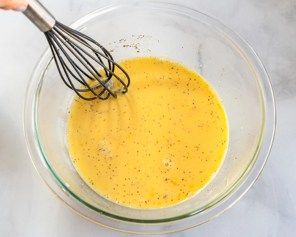 An egg mixture made with beaten eggs, salt, pepper, and milk whisked together.