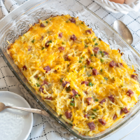 Top down view of a Breakfast Casserole make with leftover corned beef, onion, green pepper, shredded potatoes and cheese - Hostess At Heart