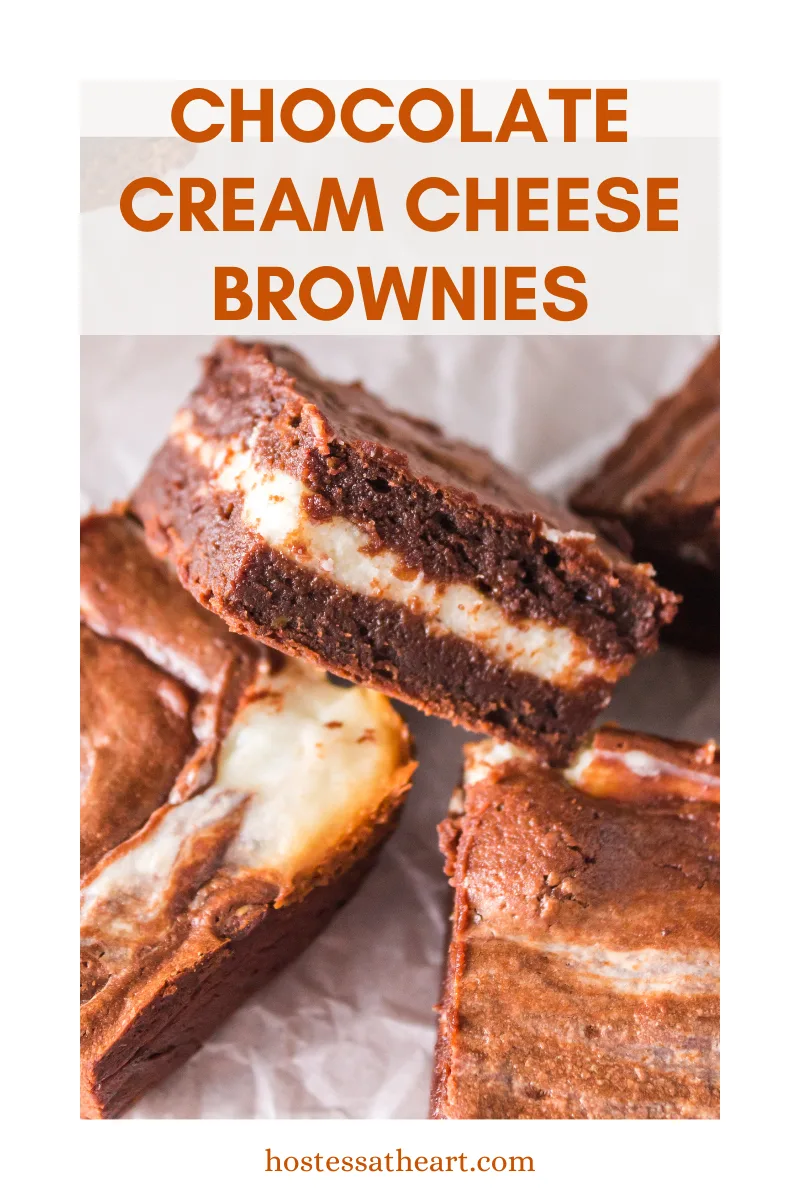 Three cut pieces of cream cheese swirl brownies with one propped up showing the layers - Hostess At Heart