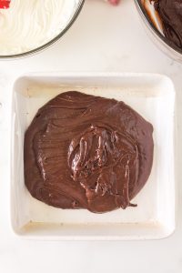 Chocolate batter poured into the bottom of a baking dish - Hostess At Heart