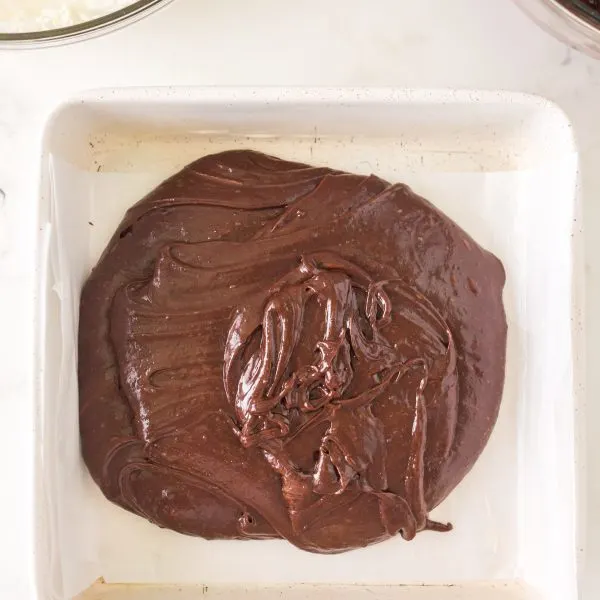 Chocolate batter poured into the bottom of a baking dish - Hostess At Heart