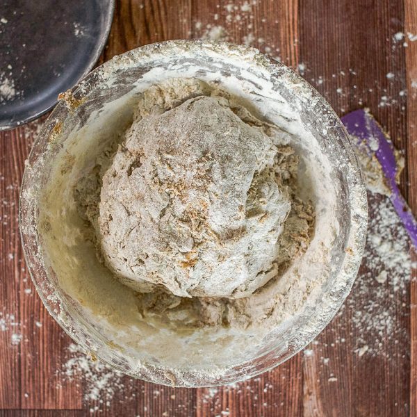 Bowl filled with craggy pumpernickel sourdough dough - Hostess At Heart