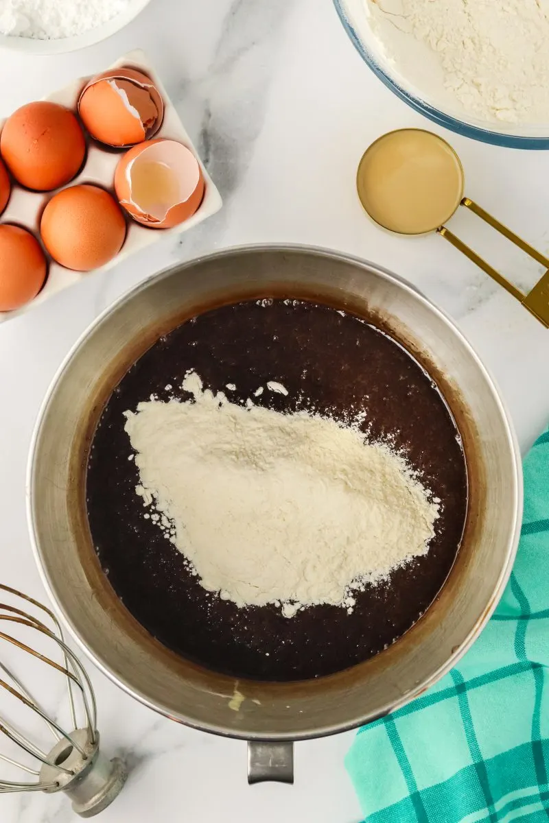 Flour and baking soda added to chocolate stout cake wet ingredients. - Hostess At Heart
