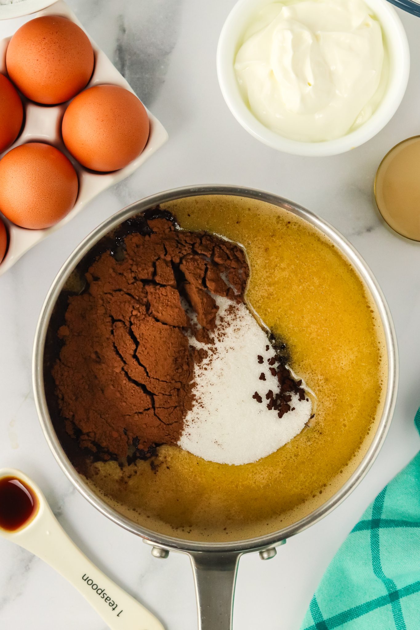 A saucepan filled with melted butter with beer, cocoa, and sugar. Hostess At Heart