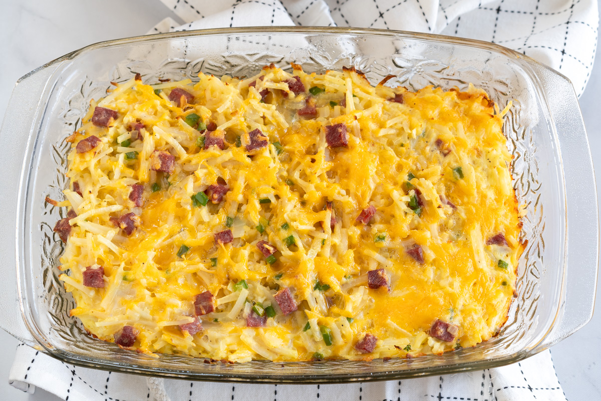 Top down view of a breakfast casserole with baked eggs, corned beef, and potatoes - Hostess At Heart