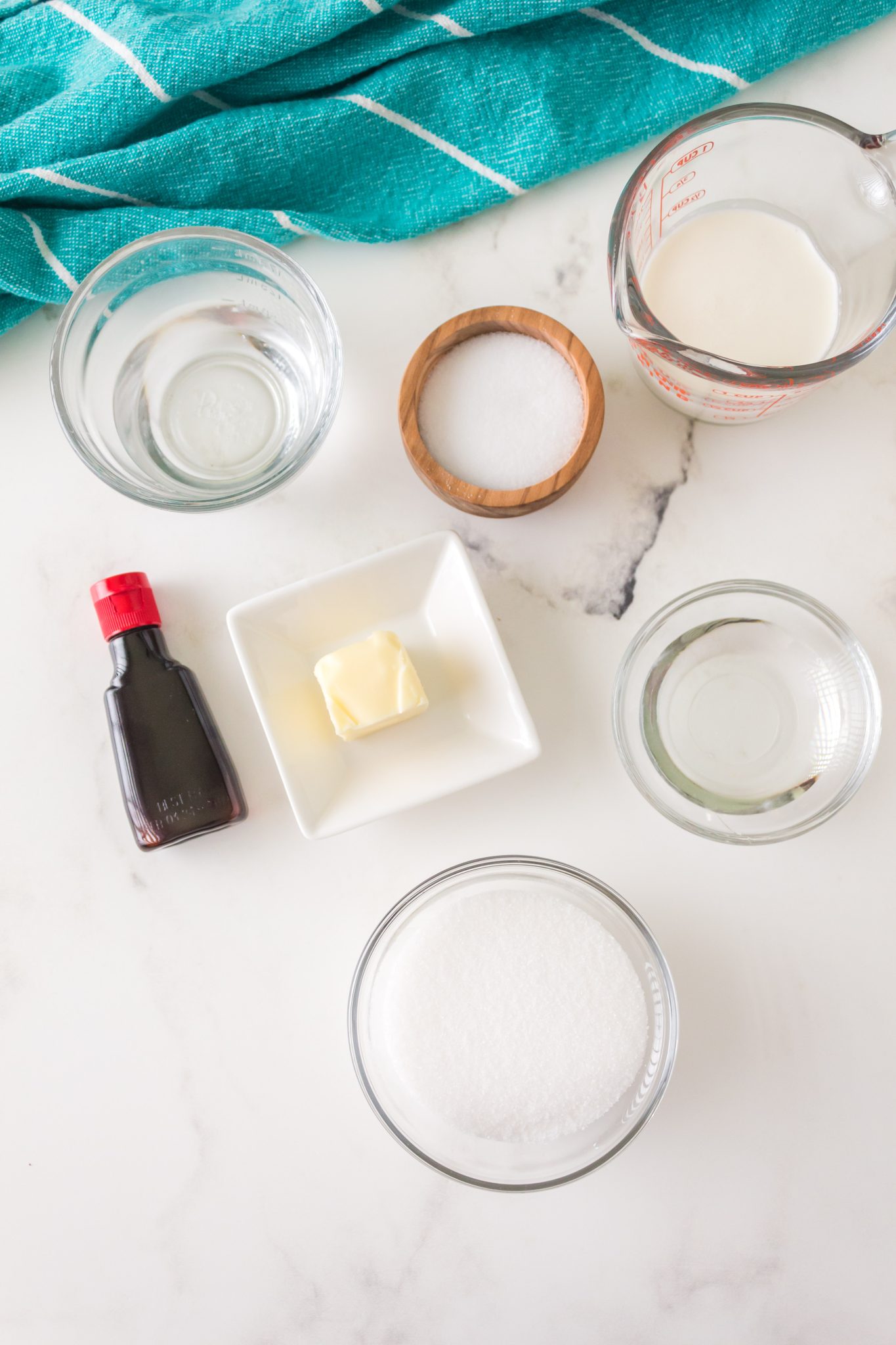 Ingredients used to make homemade caramel including light corn syrup, cream, sugar, and butter - Hostess At Heart