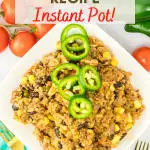 Top down view of a serving dish filled with instnat pot dirty rice recipe loaded with ground beef, corn, black beans, tomatoes and spice garnished with fresh jalapeno slices - Hostess At Heart
