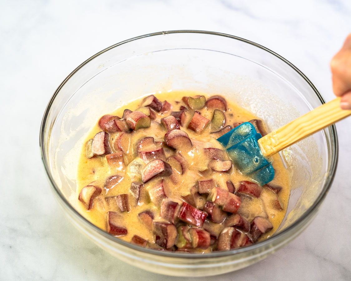 Sliced rhubarb folded into the creamy egg custard mixture for rhubarb custard piel - Hostess At Heart