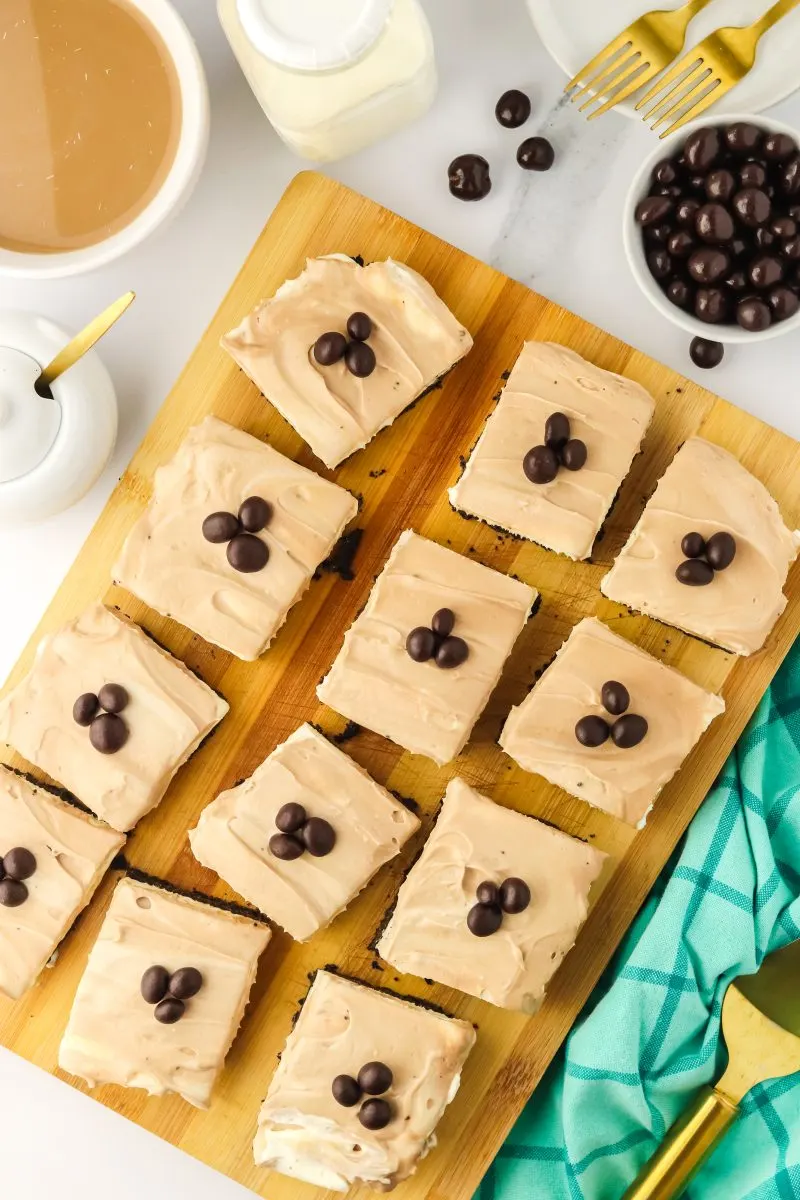 Twelve Cappucino Cheesecake Bars spread out in a pan. Hostess At Heart