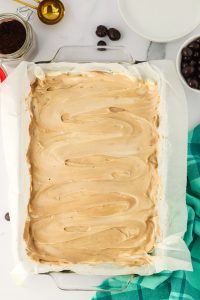 Top down view of a baking dish topped with a swirl of a layer of cream cheese filling and a cappuccino topping. Hostess At Heart
