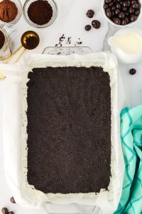 Chocolate cookie crust pressed into the bottom of a baking dish - Hostess At Heart